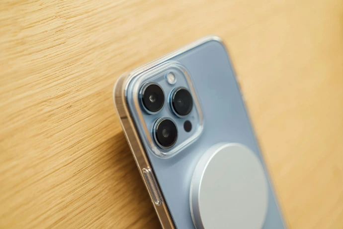 a close up of a cell phone on a wooden surface